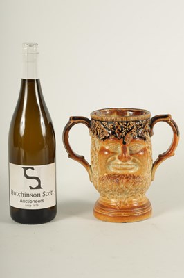 Lot 56 - AN UNUSUAL 19TH CENTURY DOULTON TYPE SALT GLAZED STONEWARE DOUBLE SIDED TWO HANDLED MASK HEAD LOVING CUP