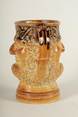 Lot 56 - AN UNUSUAL 19TH CENTURY DOULTON TYPE SALT GLAZED STONEWARE DOUBLE SIDED TWO HANDLED MASK HEAD LOVING CUP