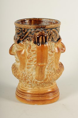 Lot 56 - AN UNUSUAL 19TH CENTURY DOULTON TYPE SALT GLAZED STONEWARE DOUBLE SIDED TWO HANDLED MASK HEAD LOVING CUP
