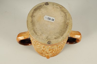 Lot 56 - AN UNUSUAL 19TH CENTURY DOULTON TYPE SALT GLAZED STONEWARE DOUBLE SIDED TWO HANDLED MASK HEAD LOVING CUP