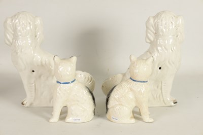 Lot 45 - A LARGE PAIR OF VICTORIAN SEATED STAFFORDSHIRE DOGS together with A PAIR OF SEATED MODELS OF CATS