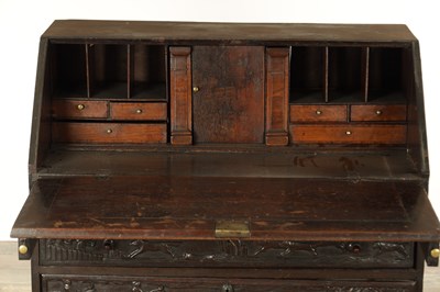 Lot 835 - A GEORGE III CARVED OAK BUREAU