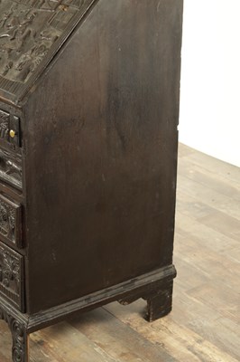 Lot 835 - A GEORGE III CARVED OAK BUREAU