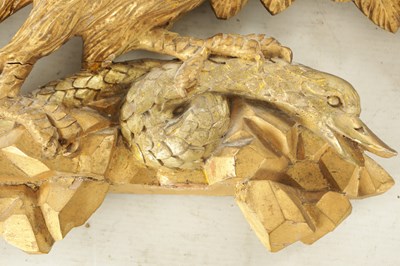 Lot 1170 - A REGENCY CARVED GILT-WOOD EAGLE WITH SERPENT