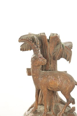 Lot 1173 - A PAIR OF LATE 19TH CENTURY CARVED BLACK FOREST CANDLESTICKS
