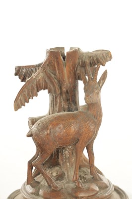Lot 1173 - A PAIR OF LATE 19TH CENTURY CARVED BLACK FOREST CANDLESTICKS