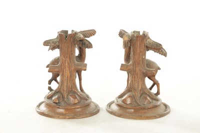 Lot 1173 - A PAIR OF LATE 19TH CENTURY CARVED BLACK FOREST CANDLESTICKS