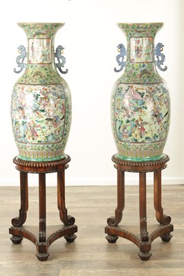 Lot 120 - AN IMPRESSIVE PAIR OF 19TH CENTURY CANTONESE CELADON GROUND AND FAMILLE ROSE HALL VASES ON LATE REGENCY ROSEWOOD STANDS