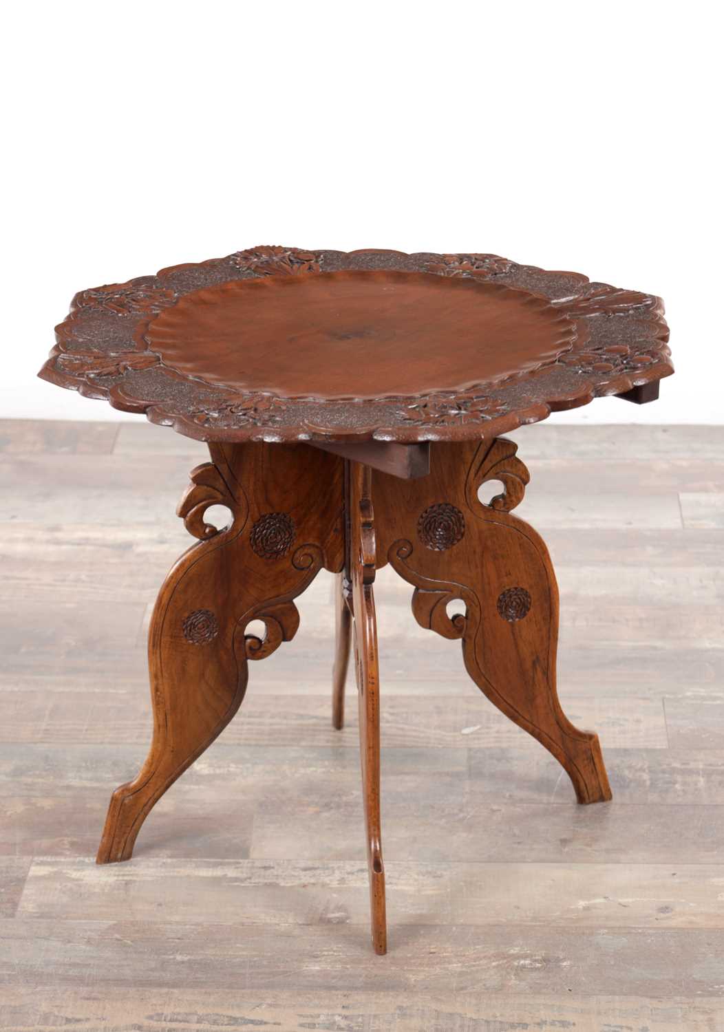 Lot 108 - A 19TH CENTURY ANGLO-INDIAN CARVED HARDWOOD FOLDING SIDE TABLE