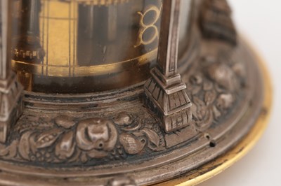 Lot 1243 - AN EARLY 17TH CENTURY SILVER AND GILT PENDULE A CERCLES TOURNANTS CLOCK WITH FIGURAL FINIAL