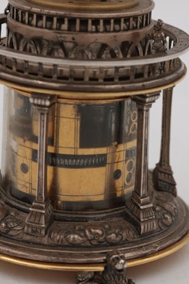 Lot 1243 - AN EARLY 17TH CENTURY SILVER AND GILT PENDULE A CERCLES TOURNANTS CLOCK WITH FIGURAL FINIAL