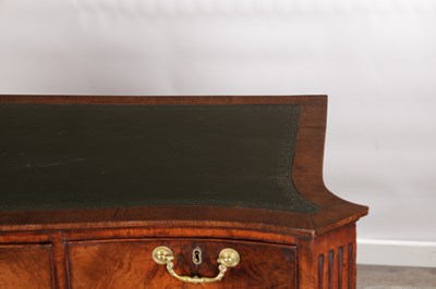 Lot 1484 - A GEORGE III FLAMED MAHOGANY SERPENTINE FRONTED KNEEHOLE DESK