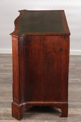 Lot 1484 - A GEORGE III FLAMED MAHOGANY SERPENTINE FRONTED KNEEHOLE DESK