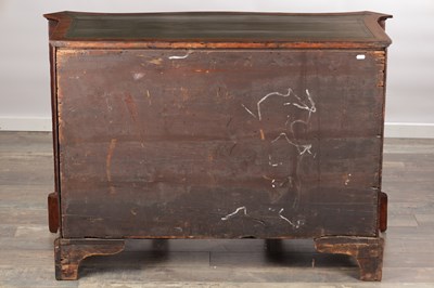 Lot 1484 - A GEORGE III FLAMED MAHOGANY SERPENTINE FRONTED KNEEHOLE DESK