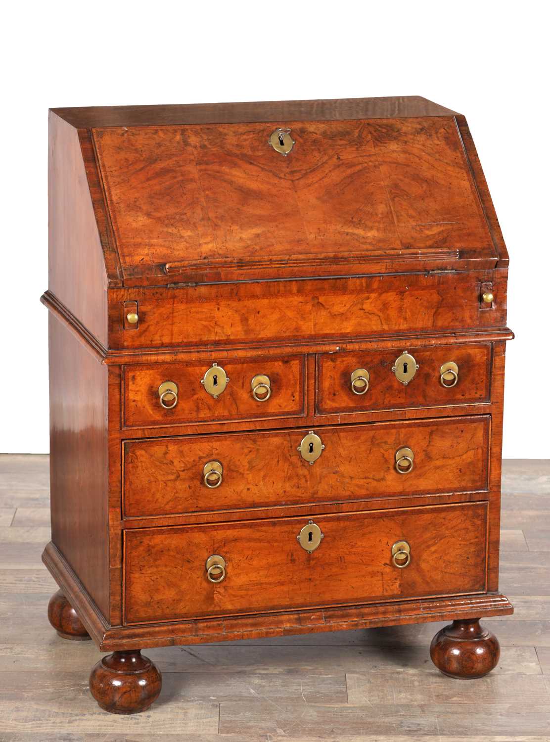Lot 1674 - A WILLIAM AND MARY HERRINGBONE INLAID FIGURED WALNUT BUREAU OF SMALL SIZE
