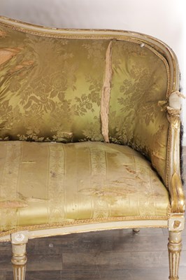 Lot 1584 - A GEORGE III PARCEL GILT AND PAINTED HEPPLEWHITE STYLE THREE SEATER SETTEE