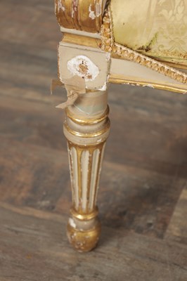 Lot 1584 - A GEORGE III PARCEL GILT AND PAINTED HEPPLEWHITE STYLE THREE SEATER SETTEE