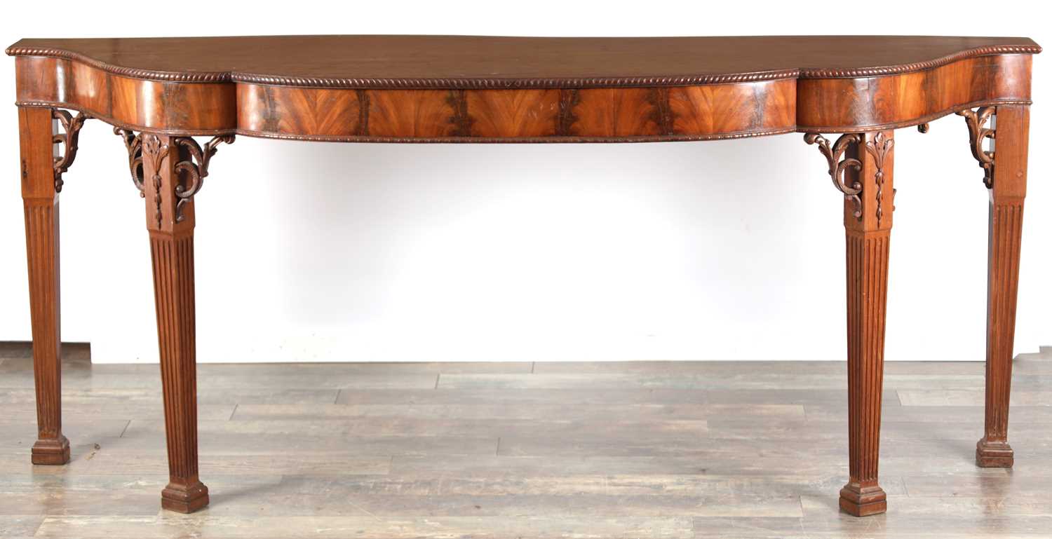 Lot 1615 - A GEORGE III FIGURED MAHOGANY SERPENTINE SERVING TABLE