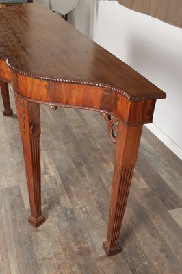 Lot 1615 - A GEORGE III FIGURED MAHOGANY SERPENTINE SERVING TABLE