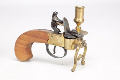 Lot 1038 - AN EARLY 19TH CENTURY BRASS AND STEEL FLINTLOCK TINDER LIGHTER WITH CANDLE SCONCE