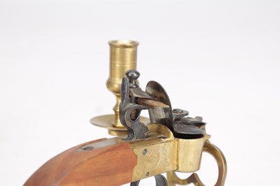 Lot 1038 - AN EARLY 19TH CENTURY BRASS AND STEEL FLINTLOCK TINDER LIGHTER WITH CANDLE SCONCE