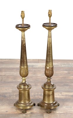 Lot 1034 - A PAIR OF LARGE BRASS CANDLESTICKS ON PAW FEET