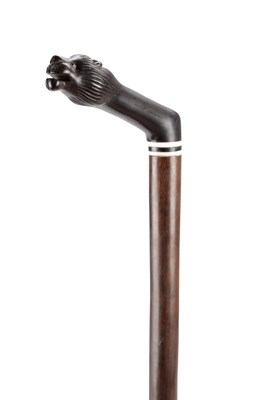 Lot 1439 - A 19TH/20TH CENTURY INDIAN HARDWOOD WALKING CANE WITH CARVED LION'S HEAD HANDLE