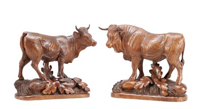 Lot 1427 - IN THE MANNER OF HUGGLER (SWISS 1834-1912) A PAIR OF 19TH CENTURY LINDEN WOOD BLACK FOREST COW AND BULL