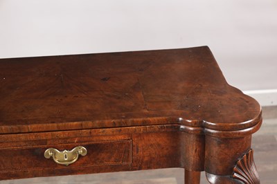 Lot 1689 - A QUEEN ANNE FIGURED WALNUT TEA TABLE