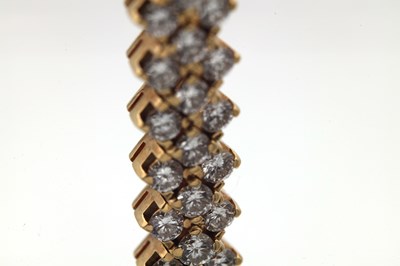 Lot 174 - AN 18CT YELLOW GOLD AND DIAMOND DOUBLE ROW BRACELET