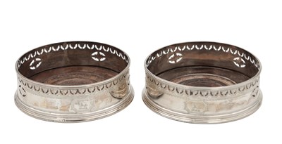 Lot 106 - A PAIR OF GEORGIAN ENGLISH SILVER BOTTLE COASTERS
