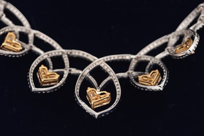 Lot 141 - AN 18CT YELLOW AND WHITE GOLD DIAMOND HEART MOTIF NECKLACE AND EARRING SET
