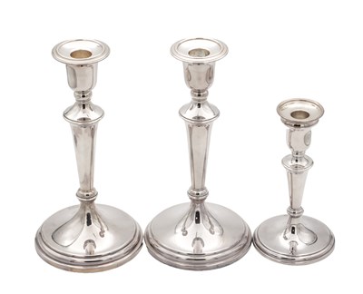 Lot 42 - A COLLECTION OF THREE EARLY 21ST CENTURY ENGLISH SILVER CANDLESTICKS BY CARRS