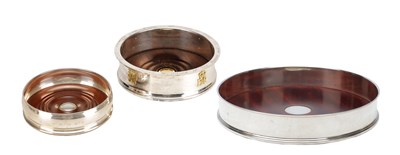 Lot 119 - A COLLECTION OF THREE ENGLISH SILVER AND MAHOGANY BOTTLE COASTERS