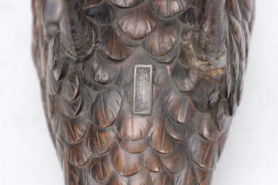 Lot 819 - A MEIJI PERIOD JAPANESE BRONZE MODEL OF A CROW ON A CARVED ROOT WOOD STAND