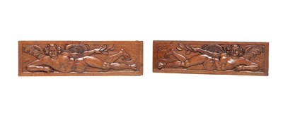 Lot 1423 - A PAIR OF 17TH CENTURY WALNUT WINGED CHERUB PANELS
