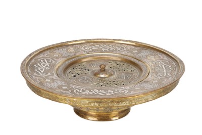 Lot 776 - A 19TH CENTURY ISLAMIC BRASS AND SILVER INLAID WASH BASIN WITH CENTRAL PIERCED STRAINER