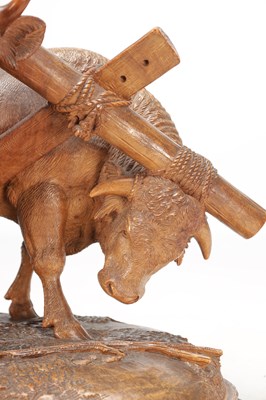 Lot 1400 - ATT JOHANN HUGLER A SWISS BLACK FOREST CARVED WOOD GROUP OF YOKED OXEN ON OVAL BASE