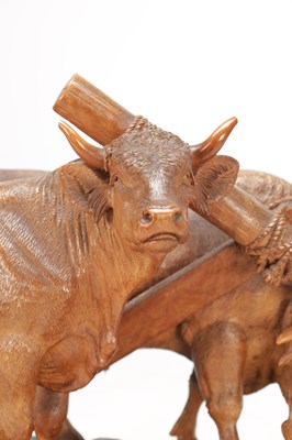 Lot 1400 - ATT JOHANN HUGLER A SWISS BLACK FOREST CARVED WOOD GROUP OF YOKED OXEN ON OVAL BASE