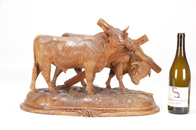 Lot 1400 - ATT JOHANN HUGLER A SWISS BLACK FOREST CARVED WOOD GROUP OF YOKED OXEN ON OVAL BASE