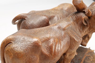 Lot 1400 - ATT JOHANN HUGLER A SWISS BLACK FOREST CARVED WOOD GROUP OF YOKED OXEN ON OVAL BASE
