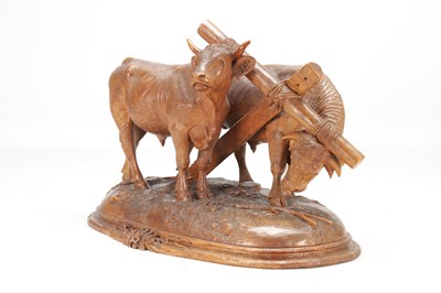 Lot 1400 - ATT JOHANN HUGLER A SWISS BLACK FOREST CARVED WOOD GROUP OF YOKED OXEN ON OVAL BASE
